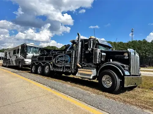 Coastal Towing black Kenworth towing RV on I-95