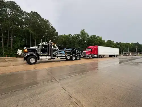 Coastal Towing wrecker towing disabled semi truck